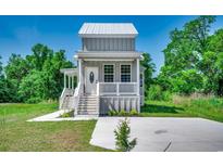Charming gray two-story home with white trim, porch, and manicured lawn at 120 Triston Ct., Little River, SC 29566