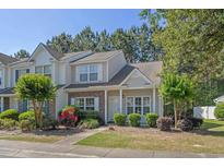 Charming townhome exterior with well-maintained landscaping, lovely flowers, and welcoming curb appeal at 1249 Shoebridge Dr. # 1249, Myrtle Beach, SC 29579