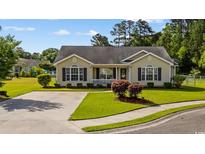 Charming single-story home with manicured lawn, inviting curb appeal, and neutral-colored siding at 1505 Bramber Pl., Conway, SC 29527