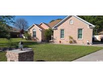 Charming brick home with a well-manicured lawn, showcasing its curb appeal and inviting exterior at 1717 Perdiz Covey Ct., Myrtle Beach, SC 29588