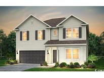 Beautiful two-story home boasting manicured lawn and attached two car garage at 2425 Watershed Way, Longs, SC 29568