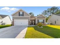 Charming home featuring a two-car garage, beautiful lawn, and classic curb appeal on a sunny day at 263 Lakota Loop, Longs, SC 29568
