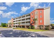 Beautiful condominium exterior with multiple balconies, lovely landscaping and street view at 311 2Nd Ave. N # 210, North Myrtle Beach, SC 29582
