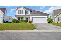 Charming two-story home with a well-manicured lawn and a two-car garage, perfect for families at 381 Winslow Ave., Myrtle Beach, SC 29588
