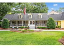 Charming one-story home featuring a welcoming porch and landscaped front yard, perfect for southern relaxation at 4023 Murrells Inlet Rd., Murrells Inlet, SC 29576