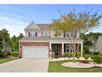 Charming two-story home with a brick facade, landscaped yard, and a two-car garage at 4246 Livorn Loop, Myrtle Beach, SC 29579