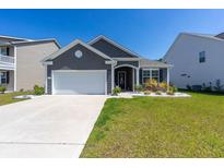 Charming single-story home with a well-manicured lawn and a two-car garage at 428 Calhoun Falls Dr., Myrtle Beach, SC 29579