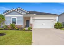 Charming single-Gathering home with a two-car garage, well-manicured lawn, and stone accents at 4609 Day Lily Run St., Myrtle Beach, SC 29579