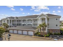 Coastal-style condo complex featuring multiple stories, private balconies and a convenient ground-level garage at 4860 Carnation Circle # 302, Myrtle Beach, SC 29577
