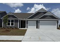 Charming single-Gathering home featuring a two-car garage, beautiful siding, and a well-manicured lawn at 531 Oak Landing Dr., Myrtle Beach, SC 29588