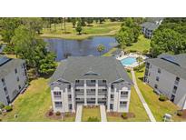 Aerial view of a beautiful condominium complex overlooking a lake, golf course, and swimming pool at 545 White River Dr. # 15 D, Myrtle Beach, SC 29579