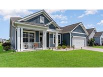 Charming home with a covered front porch and manicured lawn at 567 Hickman St., Surfside Beach, SC 29575