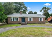 Charming brick home featuring a well-maintained front yard, inviting entrance, and classic architectural details at 605 62Nd Ave. N, Myrtle Beach, SC 29572