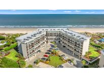 Stunning aerial view of the beachfront condo complex with a pristine sandy beach and ocean backdrop at 645 Retreat Beach Circle # A-2-C, Pawleys Island, SC 29585