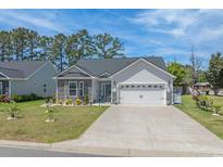 Charming home featuring stone accents, manicured lawn, and an attached two-car garage at 804 Twickenham Loop, Longs, SC 29568