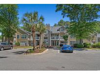 Inviting condo with two-story facade, complemented by well-manicured landscaping and ample parking at 900 Courtyard Dr. # K7, Myrtle Beach, SC 29577
