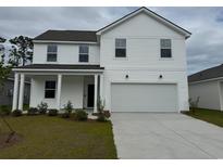 Charming two-story home with a two-car garage and a well-manicured lawn and minimalist landscaping at 945 Laconic Dr., Myrtle Beach, SC 29588