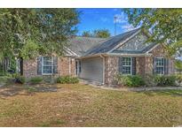 Charming brick home with well-maintained landscaping and inviting curb appeal, showcasing its classic design elements at 101 Alpharetta Ct., Conway, SC 29526