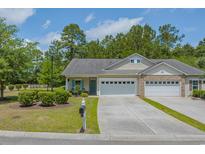 Charming single-story home featuring a two-car garage, well-manicured lawn, and lovely landscaping at 101 Fulbourn Pl., Myrtle Beach, SC 29579