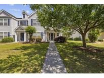 Charming two-story townhome with blue shutters and a well-manicured lawn and walkway at 1127 Harvester Circle # 1127, Myrtle Beach, SC 29579