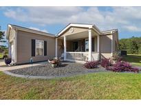 Charming one-story home with a cozy front porch and professionally landscaped yard at 133 Lakeside Crossing Dr., Conway, SC 29526