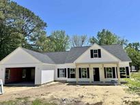 Charming one-story home featuring a covered porch and a two-car garage awaiting finishing touches at 133 Thrush Ct., Georgetown, SC 29440