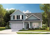Charming two-story home with light blue siding, black shutters, and a well-manicured front lawn at 1517 Seachase Way, North Myrtle Beach, SC 29582