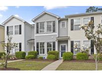 Charming townhome with gray siding, black shutters, and manicured landscaping at 157 Olde Towne Way # 4, Myrtle Beach, SC 29588