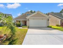 Charming single-Gathering home featuring a two-car garage and well-maintained lawn at 189 Sea Turtle Dr., Myrtle Beach, SC 29588