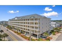 Beautiful exterior view of the multilevel condo complex with private balconies and ample parking at 200 53Rd Ave. N # 409, North Myrtle Beach, SC 29582