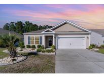 Charming single-story home with a well-manicured lawn, blue shutters, and a two-car garage at 2825 Mcdougall Dr., Conway, SC 29526