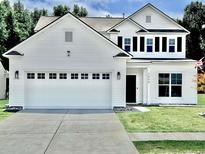 Charming two-story home with a two-car garage, dark shutters and a well-manicured lawn at 2858 Ellesmere Circle, Myrtle Beach, SC 29579