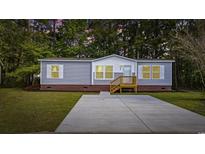Charming single-story home with vinyl siding, brick foundation, and a concrete driveway at 3175 Lyndon Dr., Little River, SC 29566