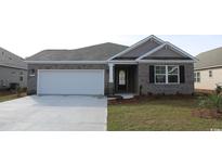Charming single-story home featuring a brick facade, attached garage, and well-maintained lawn at 325 Wingspan Ct., Myrtle Beach, SC 29588