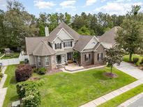 Aerial view of a two-story home with lush landscaping, a well-manicured lawn, and a brick and siding exterior at 3564 Brampton Dr., Myrtle Beach, SC 29588