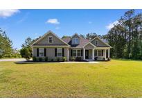 Charming single-story home with a well-manicured lawn and inviting front porch at 3926 Long Avenue Ext., Conway, SC 29527