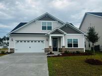 Charming single-Gathering home with a two-car garage and manicured lawn at 4031 Bucolic Loop, Myrtle Beach, SC 29588