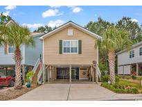Charming stilted beach house with palm trees and a covered parking area underneath at 4341 Grande Harbour Blvd., Little River, SC 29566