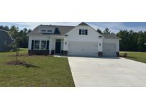 Charming two-story home with a well-manicured lawn, two-car garage and stone accents at 4750 N Huckleberry Ln., Conway, SC 29526
