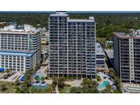 A high-rise condo building featuring pools, palm trees, and other beachside amenities at 5308 N Ocean Blvd. # 504, Myrtle Beach, SC 29577
