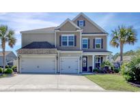 Inviting two-story home with a three-car garage, manicured lawn and lovely landscaping at 5809 Oakbury Ct., Myrtle Beach, SC 29579