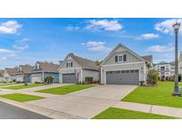 Charming street view showcasing well-maintained homes with neat lawns and attached garages at 6076 Campanella St., Myrtle Beach, SC 29577