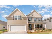 Charming two-story home with neutral siding, stone accents, and a two-car garage at 615 Fair Feather Ct., Myrtle Beach, SC 29588