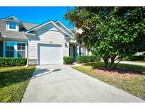 Charming home featuring a well-manicured lawn and a classic white garage door at 6172 Catalina Dr. # 214, North Myrtle Beach, SC 29582