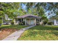 Charming single-story home with a well-maintained lawn, a paved walkway, and mature trees at 6612 Wintergreen Point, Myrtle Beach, SC 29588