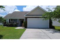 Charming single-story home featuring a two-car garage and well-maintained lawn in a peaceful neighborhood at 843 Brookline Dr., Myrtle Beach, SC 29579