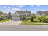 Charming single-story home with a well-manicured lawn and a two-car garage at 886 Carolina Farms Blvd., Myrtle Beach, SC 29579