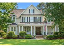 Charming two-story home with inviting front porch, columns and landscaped yard at 93 Knotty Pine Way, Murrells Inlet, SC 29576