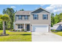 Charming two-story home with a well-manicured lawn and a two-car garage at 1748 Promise Pl., Myrtle Beach, SC 29588