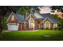Beautiful brick home with a well-manicured lawn and mature landscaping creates fantastic curb appeal at 180 Waterhall Dr., Murrells Inlet, SC 29576
